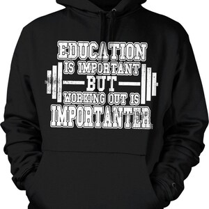 May include: Black hooded sweatshirt with white text that reads "EDUCATION IS IMPORTANT BUT WORKING OUT IS IMPORTER." The text is designed with a barbell graphic. The sweatshirt has a front pocket and a hood.