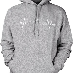 May include: A gray hooded sweatshirt with a white graphic of a kettlebell inside a heartbeat. The text "NOQUIT" is below the graphic.