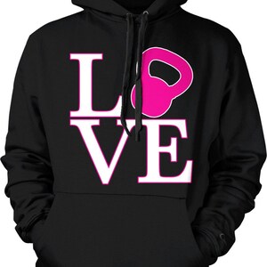 May include: Black hooded sweatshirt with a white "LOVE" graphic. The "O" in LOVE is replaced with a pink kettlebell.