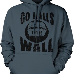 May include: A dark blue hooded sweatshirt with a black graphic print of a football and the text "GO BALLS TO THE WALL".