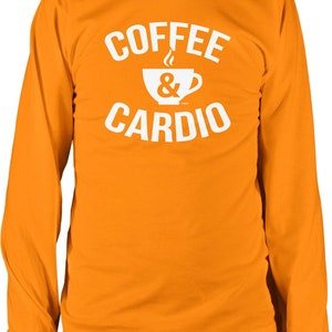 May include: Orange long-sleeve t-shirt with white text that reads "Coffee & Cardio" and a white silhouette of a coffee cup with steam coming from it.
