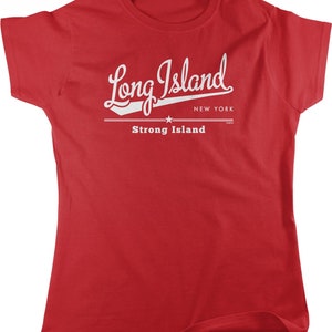 May include: Red t-shirt with a white graphic that says "Long Island" in a vintage style font with a baseball bat and star. Below the text it says "Strong Island" and "New York".