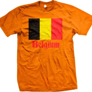 May include: Orange t-shirt with a distressed black, yellow, and red Belgian flag graphic and the word "Belgium" in red.
