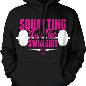 May include: Black hooded sweatshirt with a pink graphic that says "Squatting For The Swimsuit" with a white barbell graphic.