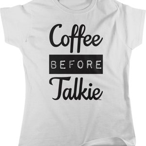 May include: White t-shirt with black text that reads "Coffee Before Talkie".