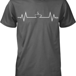 May include: A dark gray t-shirt with a white graphic of a coffee cup with steam coming out of it and a heartbeat line on either side of the cup. The text "NOFD" is on the right side of the graphic.