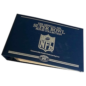 May include: A navy blue binder titled "THE OFFICIAL NFL SUPER BOWL PATCH COLLECTION" with the NFL logo. The binder commemorates America's Premier Sporting Event. The binder has silver accents and a WAW logo.