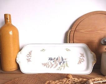 May include: White rectangular serving platter with a gold rim and a fern pattern in shades of brown, green, and gray.