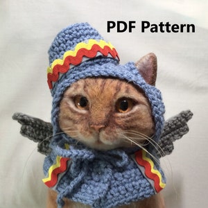 May include: A crocheted cat hat and wings pattern in blue, gray, red, and yellow. PDF Pattern.