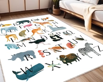 May include: A white rectangular rug featuring the alphabet with animal illustrations. Each letter is paired with a corresponding animal, such as an elephant for 'E' and a zebra for 'Z'. The rug is placed in a living room setting.