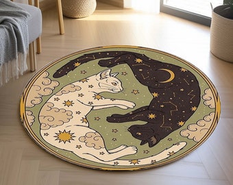 May include: A round green rug with a white cat and a black cat on it. The cats are stylized and have constellations on their bodies. The rug has a yellow border.