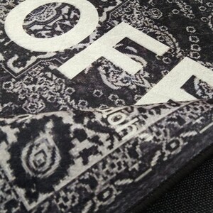 May include: Black and white patterned rug with the word "HOME" printed in white on the surface.