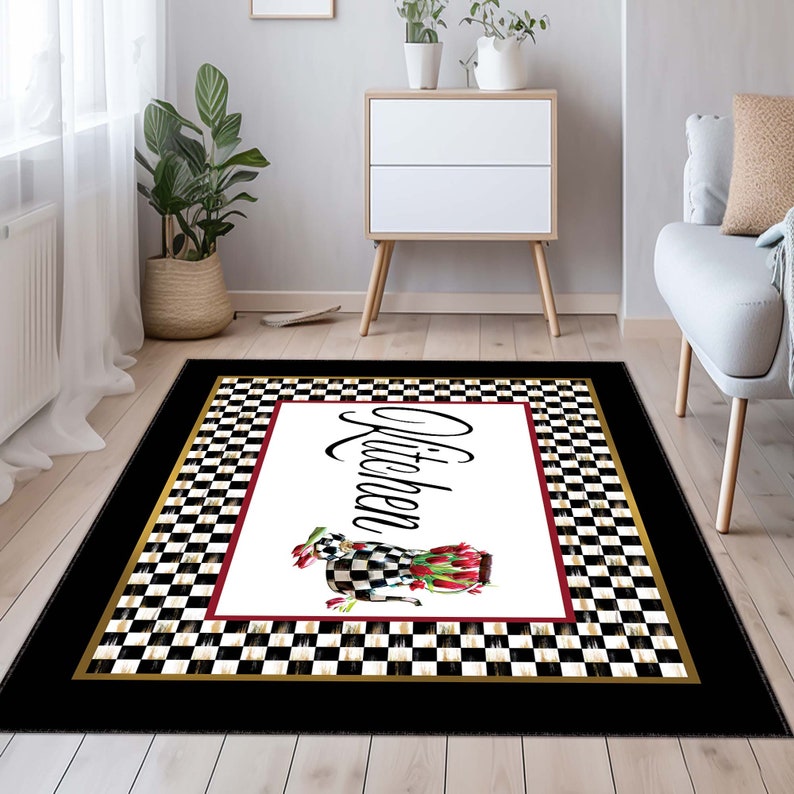 May include: A rectangular area rug featuring a central white panel with the word Kitchen in black script, accompanied by a checkered teapot filled with red tulips. The design includes a black and white checkered border and a solid black edge.