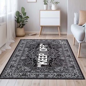 May include: Black and white patterned rug with the text "KEEP OFF" in white lettering.
