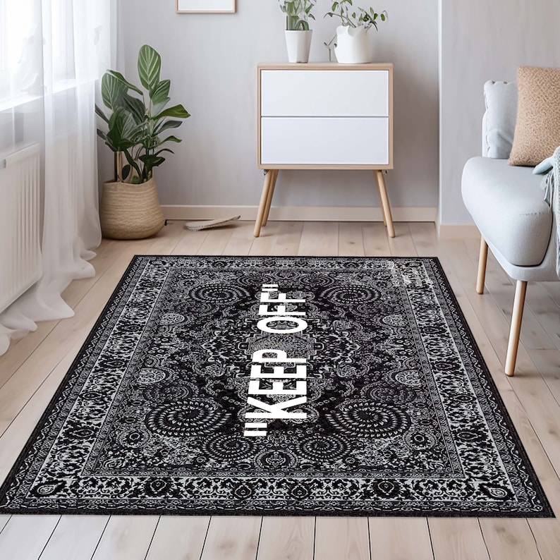 May include: Black and white patterned rug with the text "KEEP OFF" in white lettering.