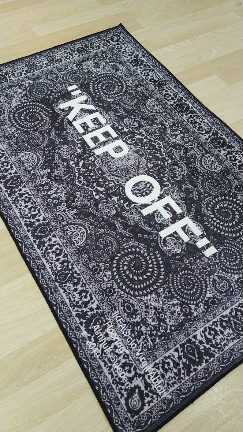 May include: Black and white patterned rug with the text "KEEP OFF!" in white. The rug has a border with a floral design. The text "IKEA Flooring" and "Almhult Sweden" is visible in the bottom right corner.