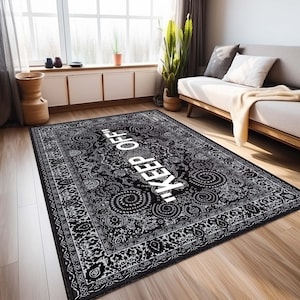 May include: Black and white patterned rug with a white "KEEP OFF" text in the center. The rug has a traditional design with intricate details.