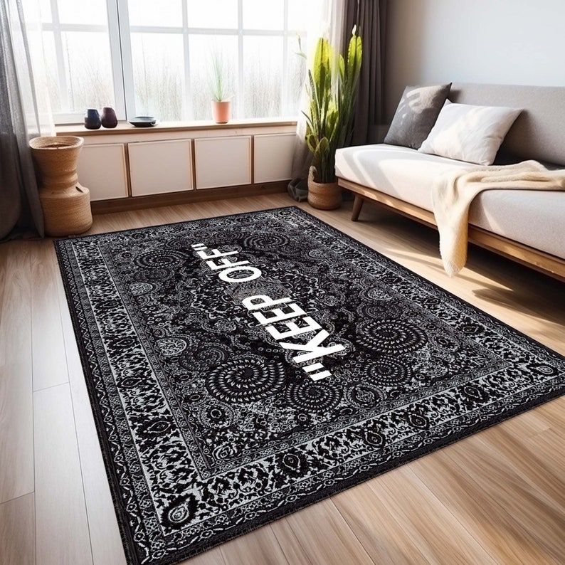 May include: Black and white patterned rug with a white "KEEP OFF" text in the center. The rug has a traditional design with intricate details.