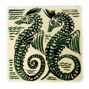 May include: Two green seahorses with wings and a black and white striped pattern on a cream background. The seahorses are facing each other and their tails are curled.