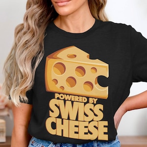 Funny Powered by Swiss Cheese Graphic T-Shirt, Humorous Cheese Lover Shirt, Unique Cheese Enthusiast Tee, Gift for Foodie Friend
