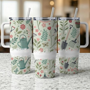 May include: Three stainless steel travel mugs with white handles and lids. The mugs feature a light green background with a floral and gardening tool pattern. The design includes watering cans, shovels, rakes, flowers, and butterflies.
