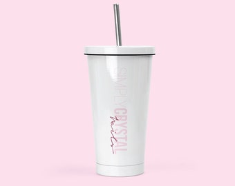 May include: White tumbler with a black lid and a silver straw. The tumbler has the text "SIMPLY CRYSTAL" in white and "Juices" in pink.