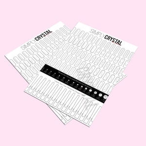 May include: Two white sheets of paper with the text "SIMPLY CRYSTAL" printed in black. The sheets are filled with outlines of nail shapes and a chart with different sizes of rhinestones.