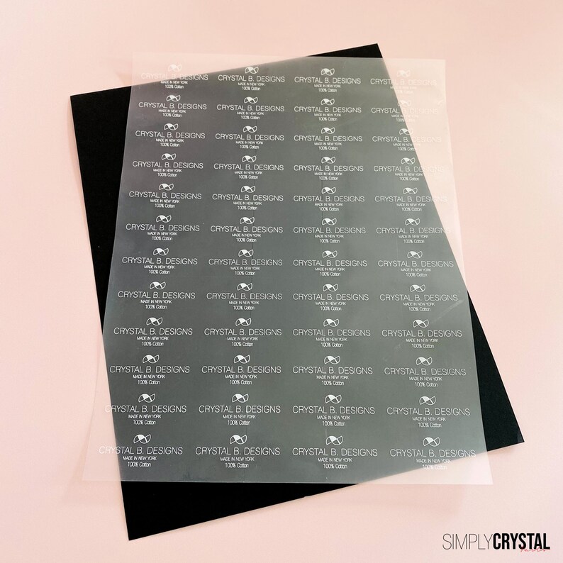 以下が含まれることがあります： 透明なラベルのシートで、"CRYSTAL B. DESIGNS MADE IN NEW YORK 100% Cotton"というテキストがグリッドパターンで繰り返されています。