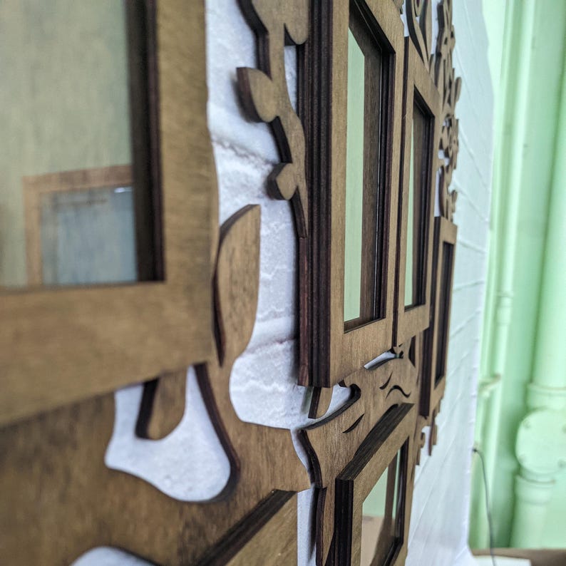 May include: A wooden picture frame with multiple openings, each with a different shape and size. The frame is made of natural wood and has a rustic look. The frame is perfect for displaying photos or artwork.