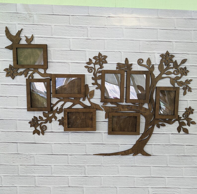 May include: A wooden wall decor in the shape of a tree with multiple photo frames. The frames are arranged in a branching pattern, creating a family tree design. The tree is painted in a dark brown color.
