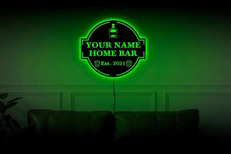 May include: Green neon sign with a black background that reads "YOUR NAME HOME BAR Est. 2021" with a bottle and two glasses icons.