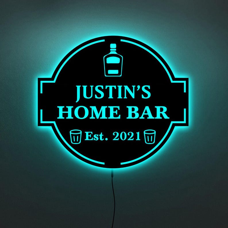 May include: A black and blue neon sign with the text "JUSTIN'S HOME BAR Est. 2021" and two shot glass icons.