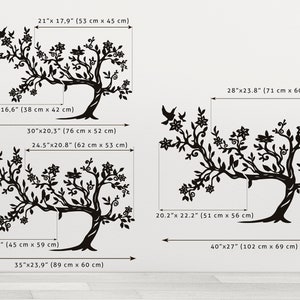May include: A set of three black and white wall decals featuring stylized tree silhouettes with intricate branches and flowers. The decals are available in various sizes, with measurements in inches and centimeters.
