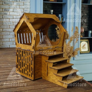 May include: A wooden pet house with a roof and a ramp. The house is brown and has a small opening for the pet to enter. The ramp is made of wood and has steps leading up to the house.