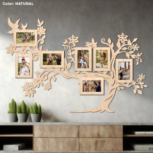May include: A wooden wall decor in the shape of a tree with eight photo frames. The frames are arranged in a branch-like pattern. The tree is painted in a natural wood color. The frames are empty and ready for photos.