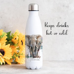May include: White stainless steel water bottle featuring a watercolour design of an elephant and the name "Jamie" printed on the bottom. The text "Keeps drinks hot or cold" is printed on the background.