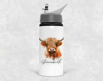 May include: White water bottle featuring a watercolor illustration of a Highland cow with long, shaggy, brown fur and curved horns. The name "Annabelle" is written in script below the cow. The bottle has a gray lid and a black spout.