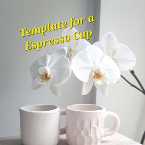 May include: Two off-white espresso cups with handles. One cup is smooth, the other has a textured, carved design. The cups are displayed with white orchid flowers and the text "Template for a Espresso Cup".