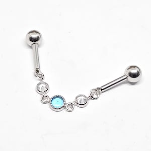 May include: Silver barbell with a chain of clear and blue gemstones. The barbell has two silver balls on each end.