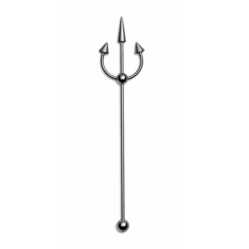 May include: A silver-colored industrial barbell body piercing. The top features a trident design with three curved prongs and a central spike. The barbell has a long, straight bar with a ball at the bottom. The piercing is shown against a white background.