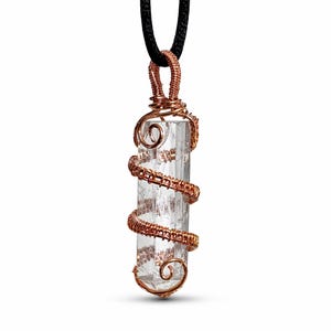 May include: A clear crystal pendant wrapped in copper wire, suspended from a black cord. The copper wire is intricately coiled around the crystal in a spiral pattern. The crystal is rectangular and has a clear, translucent appearance.
