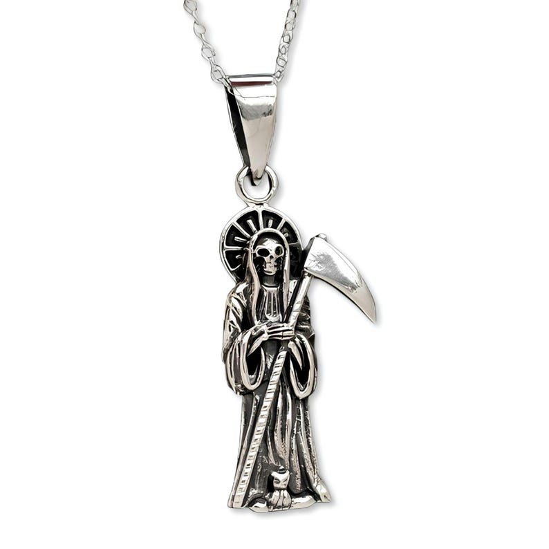 Pu&ograve; includere: Collana con ciondolo in argento che presenta una rappresentazione dettagliata della Morte che tiene una falce. Il ciondolo ha un teschio nero con un'aureola e un piccolo gatto alla base.