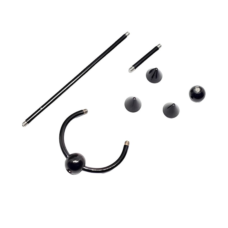 May include: A set of black body jewelry, including a curved barbell with a ball end, a straight barbell with a ball end, and three conical ends.