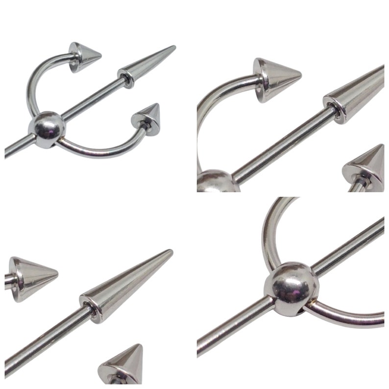 May include: A silver industrial barbell body piercing jewelry with a trident design. The barbell features a long, straight bar with a central sphere and three pointed ends. The ends are cone-shaped and the overall design is symmetrical.