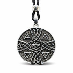 May include: A silver-colored pendant necklace with a black cord. The round pendant features a textured surface with a Celtic knot design, triangles, and a central pentagram. The necklace is a piece of jewelry.