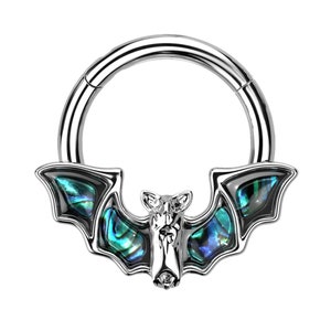 May include: A silver septum ring with a bat motif. The bat's wings are adorned with iridescent abalone shell, showing blue, green, and black hues. The bat's head is detailed with a small nose and ears.