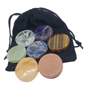 May include: Set of seven smooth, round, polished stones in a black velvet pouch. The stones are clear quartz, green aventurine, blue sodalite, rose quartz, amethyst, tiger's eye, and clear quartz.