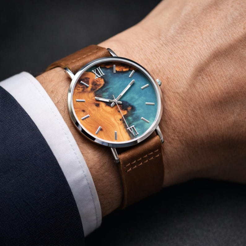 Men’s blue dial wristwatch with leather strap shown on a hand, ideal as an engraved groom watch or personalized groomsmen watch gift.