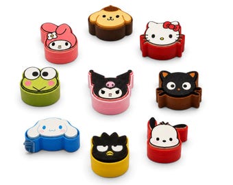 May include: A collection of nine Sanrio character stamps featuring Hello Kitty, My Melody, Kuromi, Keroppi, Chococat, Cinnamoroll, Badtz-Maru, Pompompurin, and Pochacco. Each stamp has a colorful plastic base matching the character's design and color scheme.