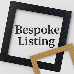 May include: A black picture frame with the text "Bespoke Listing" inside. A smaller, natural wood frame is partially visible in the bottom right corner.